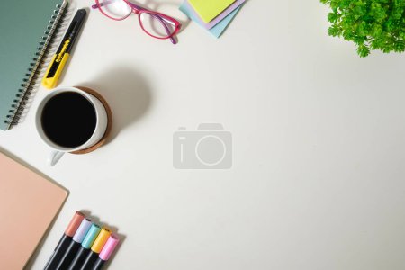 Photo for A cup of coffee, glasses and stationery on white table. Top view with copy space for your text. - Royalty Free Image