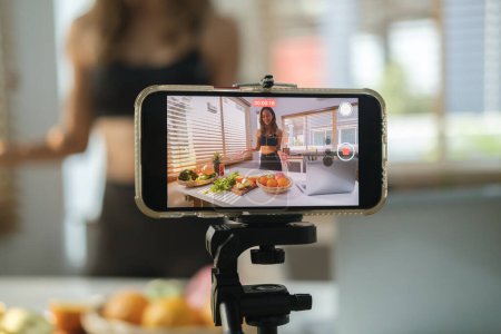 Photo for Screen of smartphone recording video content about healthy nutrition at home. Vlogging and freelance job concept. - Royalty Free Image