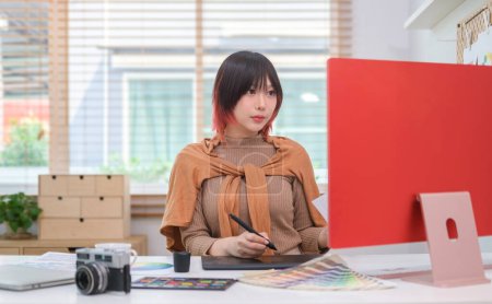 Photo for Focused young woman graphic designer working on design at workplace. - Royalty Free Image