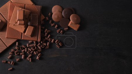 Photo for From above composition of assortment of fine chocolates on dark background with copy space. - Royalty Free Image