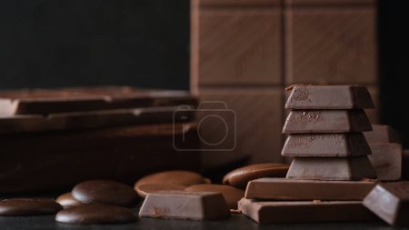 Photo for Stack of milk chocolate and dark chocolate bars on black background. Dessert food background. - Royalty Free Image