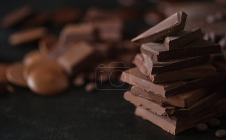 Photo for Closeup shot, of dark chocolate chunks on black background. Dessert food background. - Royalty Free Image