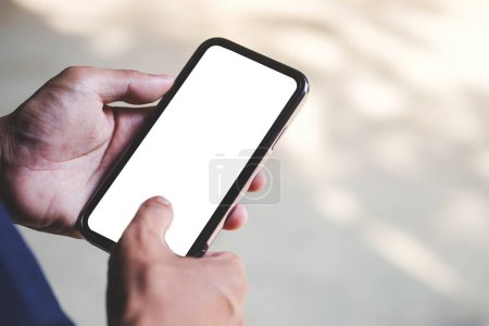 Téléchargez les photos : Close up view of man holding mock up smart phone with blank screen. - en image libre de droit