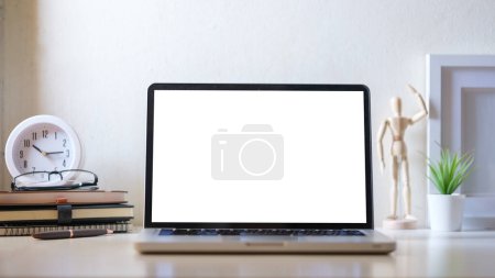 Photo for Laptop computer, coffee cup, potted plant and picture frame on creative workplace. Blank screen for your advertise text. - Royalty Free Image