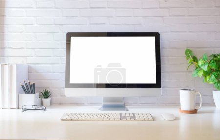 Photo for Front view blank desktop computer screen, picture frame and pencil holder on white table. - Royalty Free Image