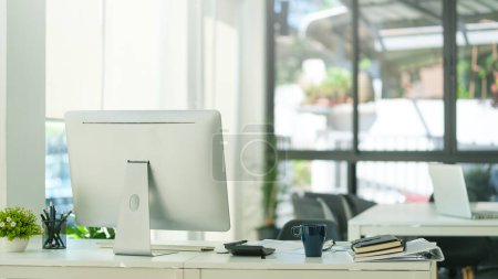 Photo for Modern workplace with computer monitor, coffee cup and office supplies on white table. - Royalty Free Image