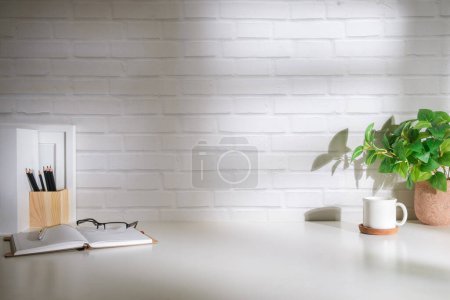Photo for Comfortable office room with office supplies and copy space on white desk. - Royalty Free Image