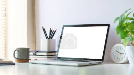 Photo for Mock up laptop computer, coffee cup and potted plant on white table. Empty screen for your advertise text. - Royalty Free Image