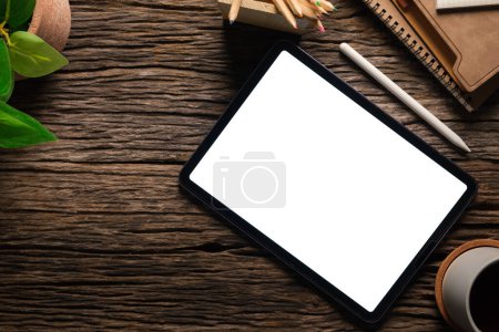 Photo for Top view modern workspace with digital tablet, stylus pen and coffee cup on wood table. - Royalty Free Image