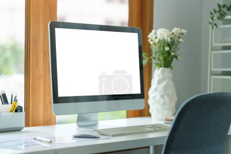 Foto de Comfortable workspace with blank screen comput and office supplies on a white wooden desk. - Imagen libre de derechos