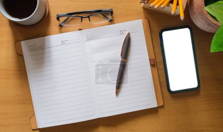 Téléchargez les photos : Top view of blank notepad, pen, cup of coffee, houseplant on table. - en image libre de droit
