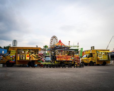 Photo for Bukit Jalil, Malaysia - Aug 16, 2022 Food trucks selling various selections at the Euro Fun Park fun fair at night. - Royalty Free Image