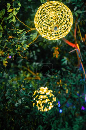 Photo for Led lights on the trees in the garden. Neon fairy party. - Royalty Free Image
