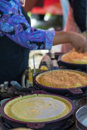 Téléchargez les photos : Apam balik est une crêpe moelleuse d'Asie du Sud-Est avec du maïs crème et des arachides. Cette crêpe molle est généralement faite sur commande sur le marché de rue. - en image libre de droit