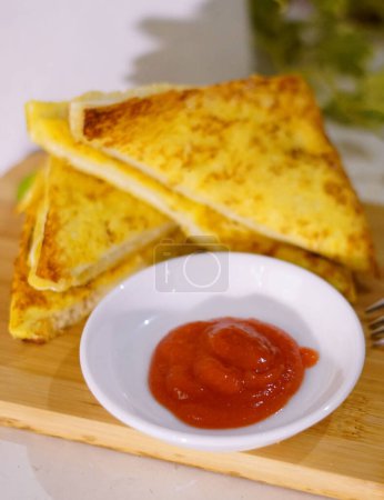 Fresh fried delicious french toast sandwich with cheese filling plated in white plate, just freshly fried in the restaurant