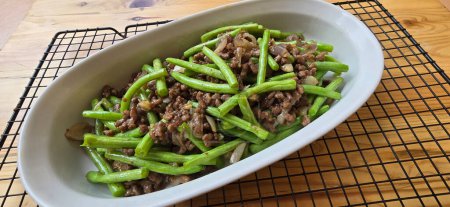 String green bean or french beans with minced beef stir fry or sauteed called Tumis buncis daging sapi cincang in Indonesia, selective focus
