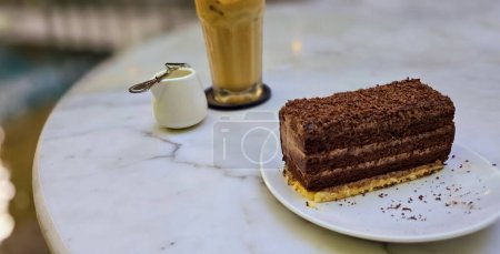 Homemade chocolate layered cake with cream layer within and topped with rich chocolate shavings, chocolate cake, Ideal for cooking recipe multimedia content creation