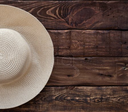Photo for Half of top view of straw beach hat on wooden background. Space for text - Royalty Free Image