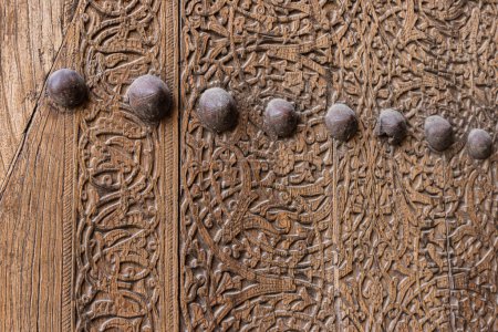 texture of an ancient wooden door in Central Asia, wood carving, ornament, Uzbekistan