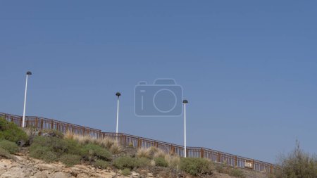 Photo for Sunny hillside path with scenic views - Royalty Free Image