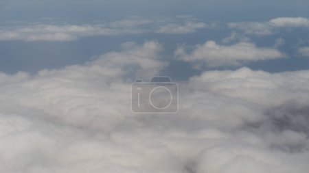 Fluffy clouds, tranquil aerial beauty.