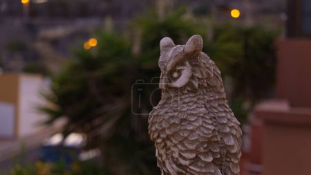 Serene owl sculpture in twilight garden