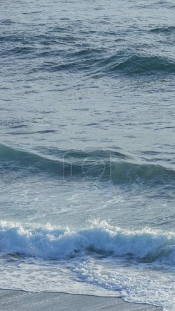 Captivating ocean waves meet sandy shore
