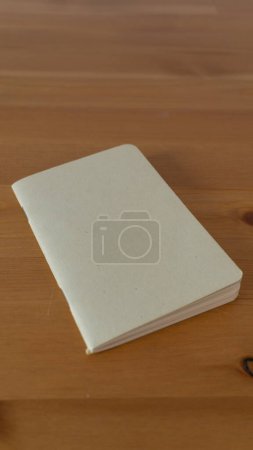 Elegant, blank journal on textured wooden surface, inspiring creativity
