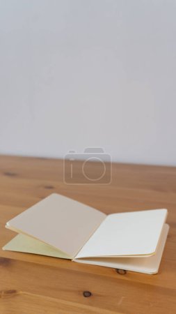Photo for Blank notebook on wooden desk - Royalty Free Image