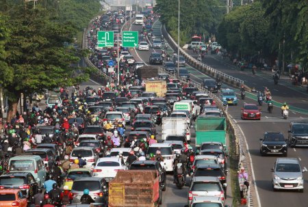 Photo for Jakarta, Indonesia-May 14, 2023: Busy traffic with chaotic vehicles scrambling on the highway. - Royalty Free Image