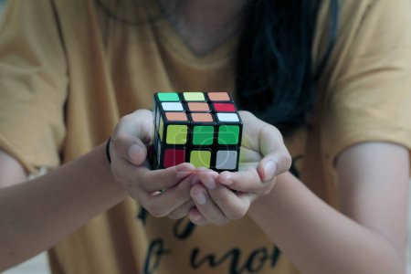 Photo for Jakarta, Indonesia - July 01, 2023 : Close up female hand holding a Rubik's cube. - Royalty Free Image