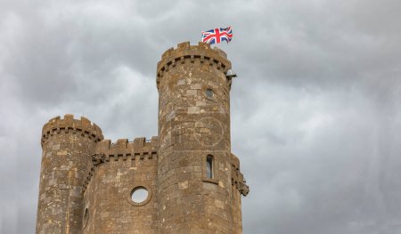 Photo for Looking upwards at a castle with circular windows against a grey sky - Royalty Free Image