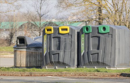 Large easy to remove recycling bins in a park in France made of wood and plastic