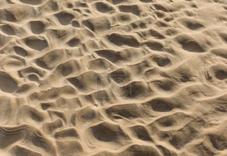 Background of dry sand where waves have previously crated a ripple pattern