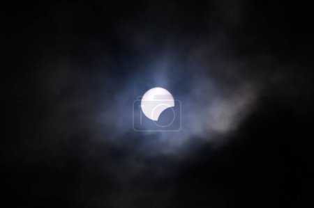 Toronto, ON, Canada - April 8, 2024: Partial solar eclipse 2024 seen from a cloudy sky near Toronto in Canada