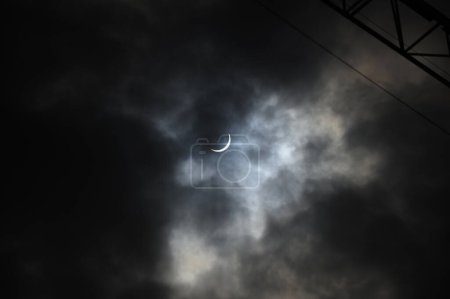 Toronto, ON, Canada - April 8, 2024: Partial solar eclipse 2024 seen from a cloudy sky near Toronto in Canada