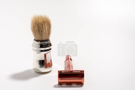 Metal razor and pen brush on a white background. Razor close-up.