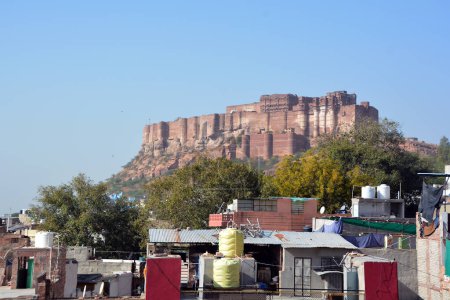 Photo for JODHPUR RAJASTHAN INDIA - 02 13 2023: Top view of Mehrangarh fort with distant view of blue city Jodhpur. Jodhpur One of the seven gates to enter the huge fort is seen below - Royalty Free Image