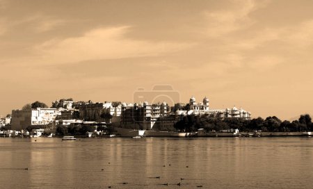 Photo for UDAIPUR RAJASTHAN INDIA - 02 20 2023: Constructions along the Lake Pichola shoreline. Lake Pichola is an artificial fresh water lake, created in the year 1362. - Royalty Free Image