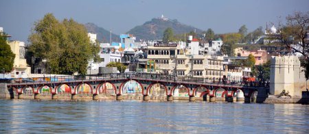 Photo for UDAIPUR RAJASTHAN INDIA - 02 20 2023: Constructions along the Lake Pichola shoreline. Lake Pichola is an artificial fresh water lake, created in the year 1362. - Royalty Free Image