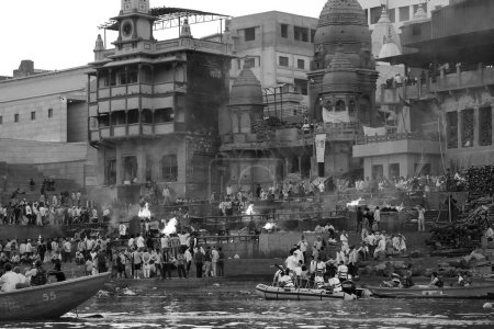 Photo for VARANASI BHOJPUR PURVANCHAL INDIA - 03 05 2023: View of the ceremony of the cremation of a unknown Hindu person at Manikarnika Ghat front the Ganges river in Varanasi - Royalty Free Image