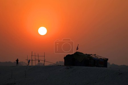 Photo for The sun rises over the eastern riverbank of the Ganges River near Varanasi, India. - Royalty Free Image