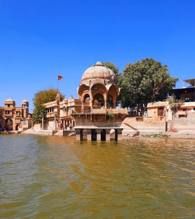 Photo for JAISALMER RAJASTHAN INDIA - 02 13 2023: Gadisar lake in the morning. Man-made water reservoir with temples in Jaisalmer. Rajasthan. India - Royalty Free Image