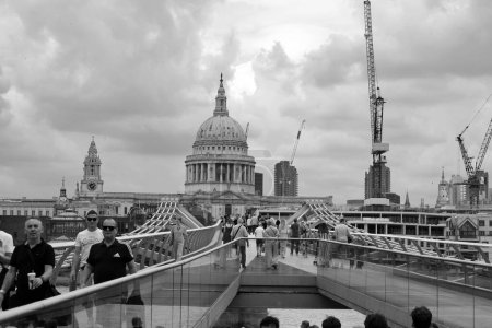 Photo for LONDON ,UNITED KINGDOM 06 17 2023: The Millenium Bridge and Saint Paul Cathedral on a typical cloudy day in London - Royalty Free Image