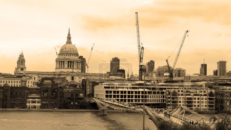 Photo for LONDON, UNITED KINGDOM 06 17 2023: The Millenium Bridge and Saint Paul Cathedral on a typical cloudy day in London - Royalty Free Image