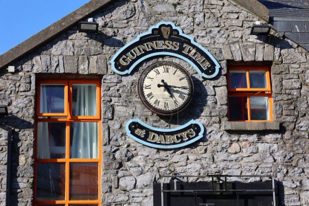Foto de GALWAY REPUBLIC OF IRLAND 05 29 2023: Clock of Guinness is an Irish dry stout that originated in the brewery of Arthur Guinness at St. James's Gate, Dublin, Ireland, in 1759 - Imagen libre de derechos