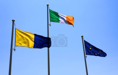 Téléchargez les photos : Wicklow flag, blue yellow irish county banner, irish flag and European union flag on blue sky - en image libre de droit