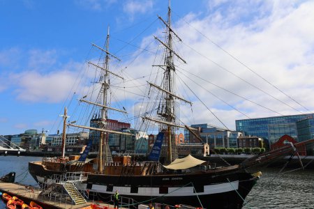 Photo for DUBLIN REPUBLIC OF IRELAND 05 28 2023: Famine to North America on board the Jeanie Johnston, a replica famine ship situated in Dublin's Docklands and the Samuel Beckett Bridge in background - Royalty Free Image