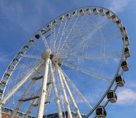 Photo for LIVERPOOL UNITED KINGDOM 06 07 2023: Wheel of Liverpool is a transportable Ferris wheel installation on the Keel Wharf waterfront of the River Mersey in Liverpool. The wheel is near to MS Bank Arena - Royalty Free Image