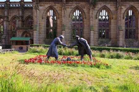 Photo for LIVERPOOL UNITED KINGDOM 06 07 2023: A sculpture commemorating the All together now statue by Andy Edwards, commemorating the Christmas Day 1914 truce, stands in grounds of St Luke's Church in Live - Royalty Free Image